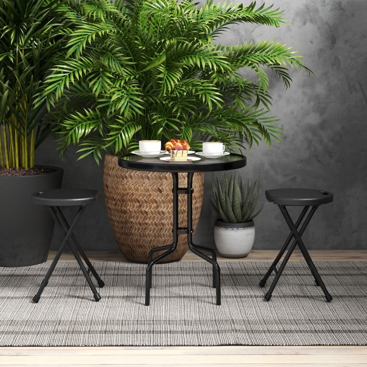 Collapsible black round stools with handles, featuring a sturdy metal frame, ideal for versatile indoor and outdoor use.