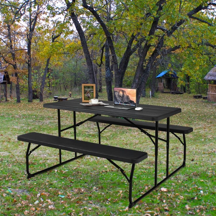 Close-up of the wood-like texture on the black folding picnic table, showcasing its durable surface for outdoor use.