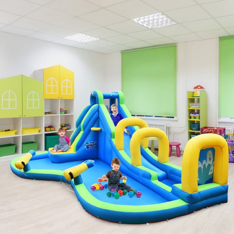 Inflatable water slide bounce house with climbing wall, splash pool, and water cannons for kids aged 4-12 years.