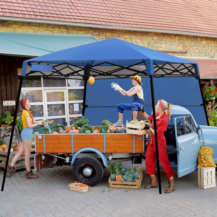 Blue 7 x 7 feet portable canopy tent in use at an outdoor market, providing shade for a gathering with fresh produce.