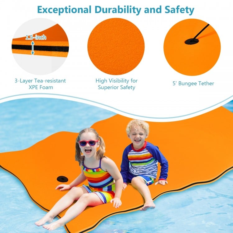 Bright orange 3-layer tear-proof water mat with bungee tether for safety, ideal for lakes, pools, and beach relaxation.