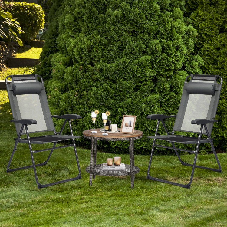 Two gray adjustable folding recliner chairs with a round coffee table, perfect for outdoor relaxation in the garden.