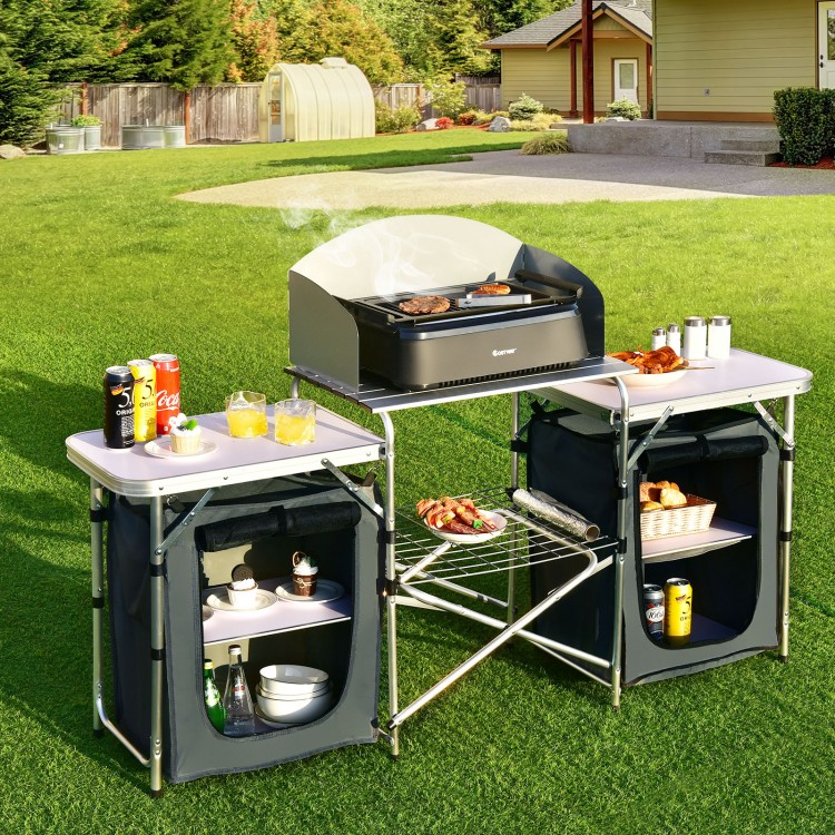 Folding camping table with storage organizer, featuring a large heat-resistant countertop and side tables for outdoor.