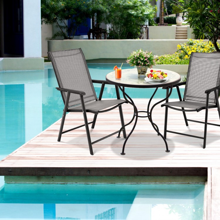 Two gray folding patio chairs with steel frames set around a round table, perfect for outdoor gatherings and camping.