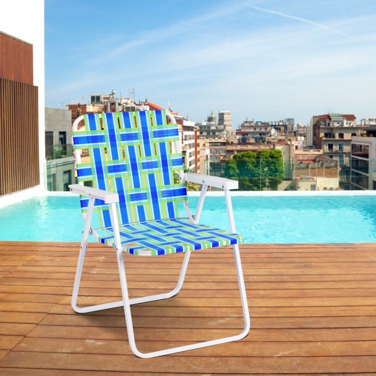 Folding beach chair in blue webbing with a sturdy steel frame, perfect for camping or lawn use by the poolside.