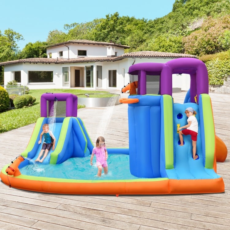 Inflatable dual water slide bounce house with sprayers, climbing wall, and water guns for summer fun in the backyard.