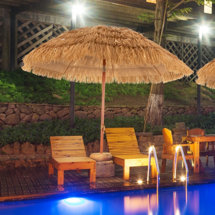 Thatched tiki beach umbrella with adjustable tilt, ideal for poolside relaxation and outdoor enjoyment.