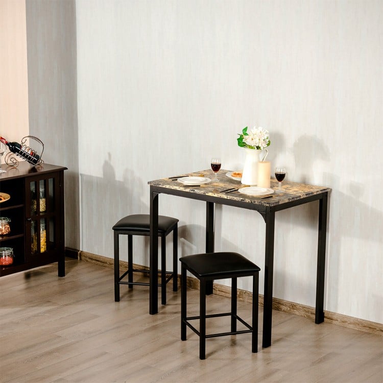 Counter height faux marble table set with two black stools, perfect for small kitchens or dining areas.