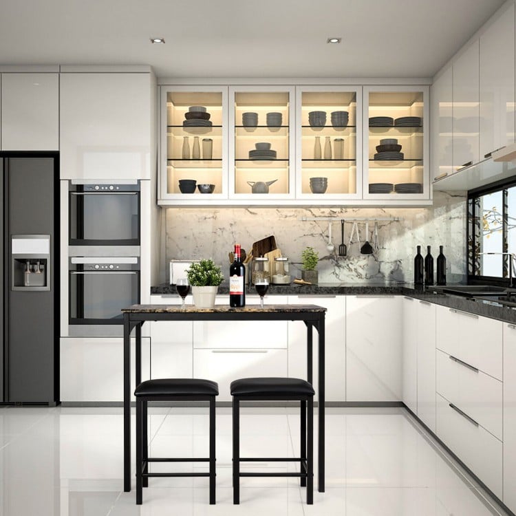 3-piece kitchen counter height set featuring a faux marble table and two black stools, perfect for small spaces.
