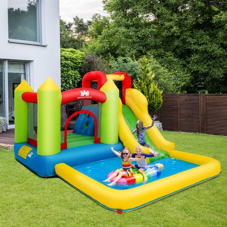 Brightly colored outdoor inflatable bounce house with water slide, perfect for garden fun and children's safety.