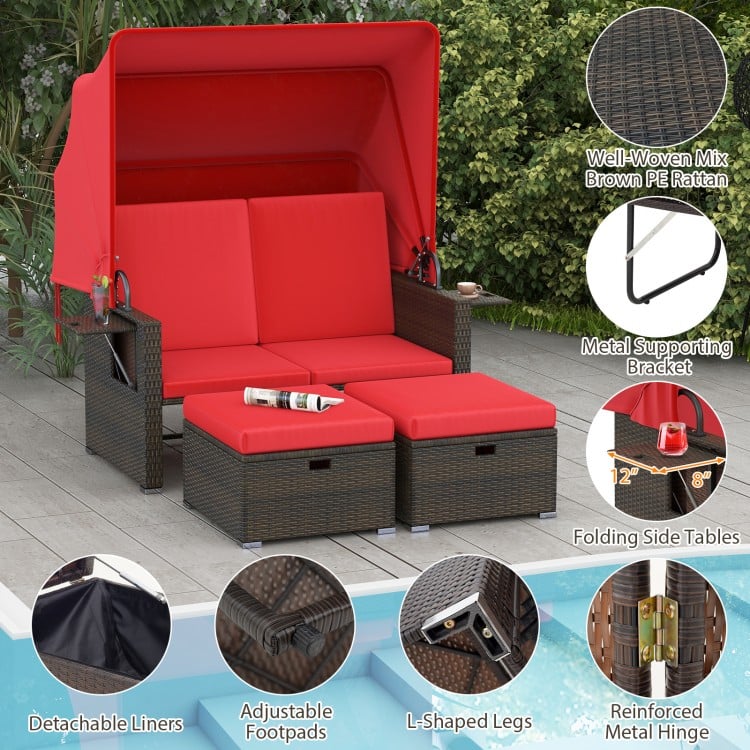 Outdoor patio rattan daybed with retractable canopy, red cushions, and adjustable backrests for backyard relaxation.
