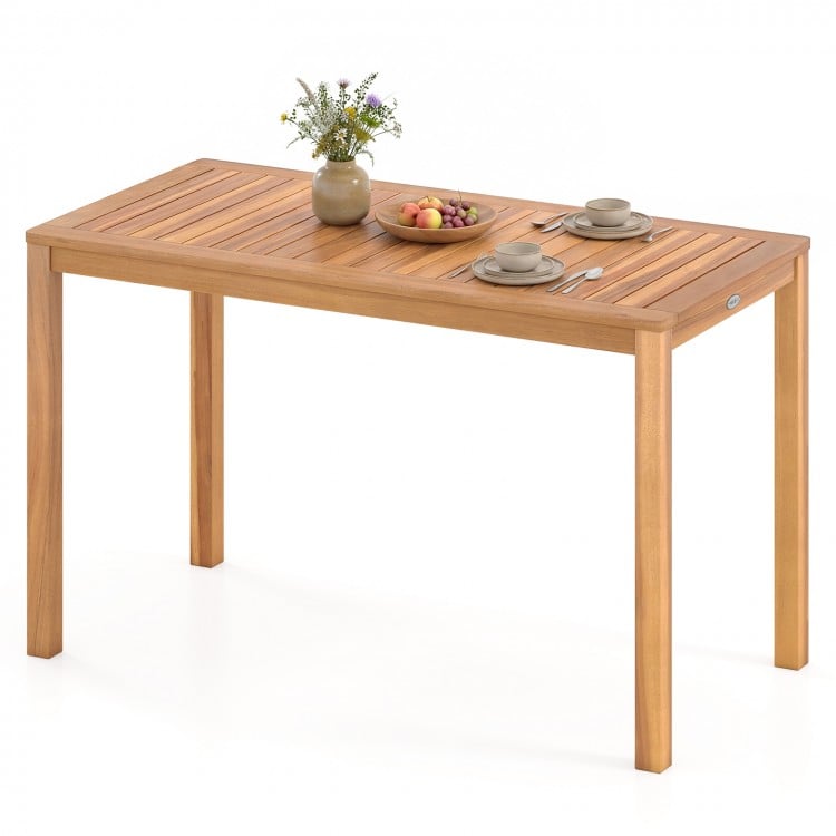 Outdoor acacia wood dining table with slatted tabletop, accommodating 4-6 people, ideal for patio or garden use.