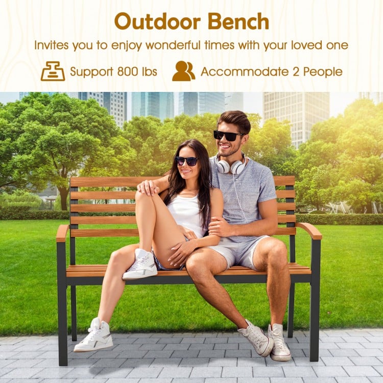 Outdoor bench made of acacia wood with backrest and armrests, supports 800 lbs, ideal for patio or garden relaxation.