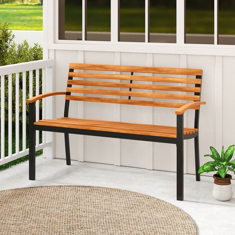 Acacia wood outdoor bench with backrest and armrests, featuring a sturdy metal frame, ideal for patio or garden use.