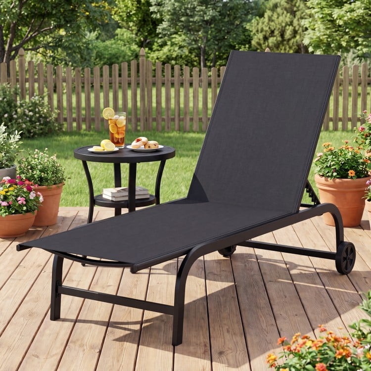 Black outdoor chaise lounge chair with wheels and metal frame, perfect for relaxing on the patio or deck.