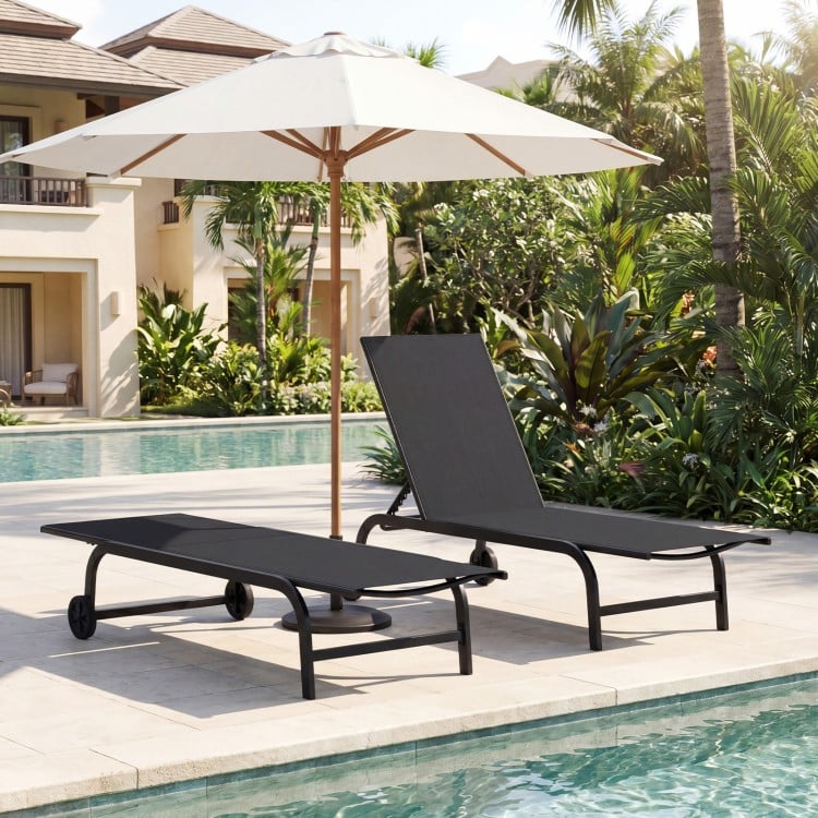 Black outdoor chaise lounge chair with wheels and metal frame, positioned by the poolside for relaxation.