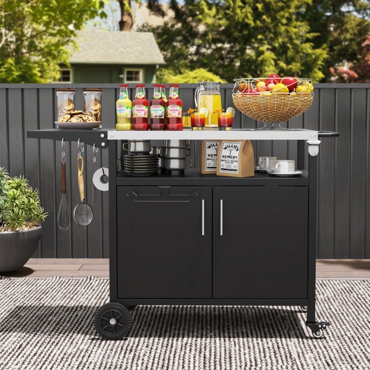 Outdoor grill cart with a stainless steel top and side table, featuring storage space and convenient accessories for.