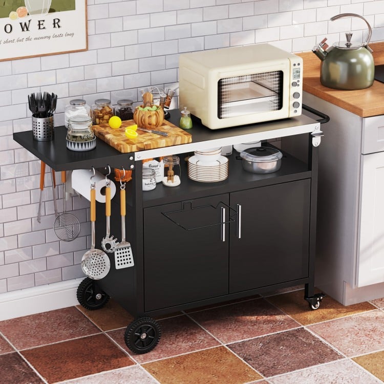Outdoor grill cart with a folding stainless steel top, featuring storage space, wheels, and convenient accessories for.