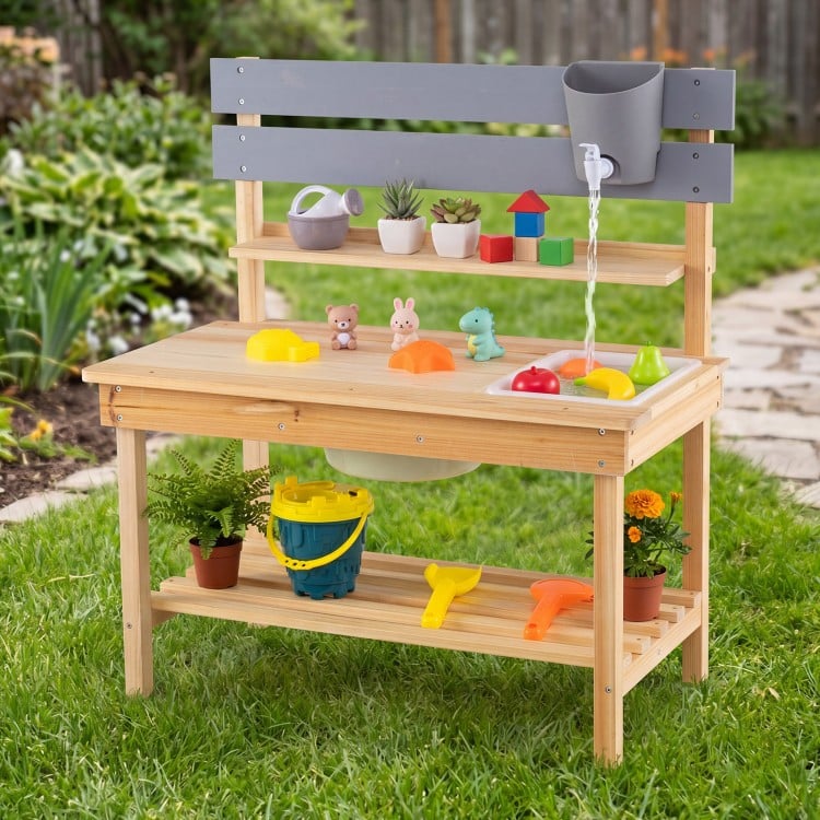 Outdoor kids mud kitchen featuring a natural fir wood design, pull-out tabletop, and built-in water basin for.