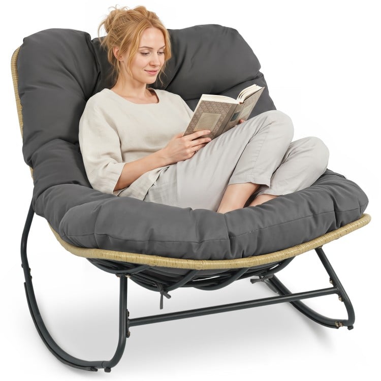 Gray Outdoor Papasan rocking chair with thick cushioned seat, ergonomic design for patio relaxation.