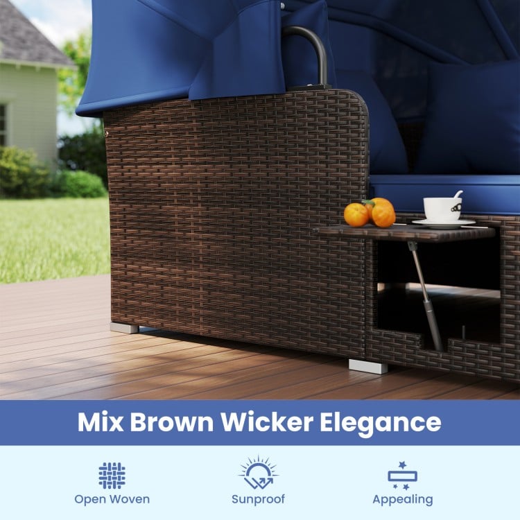 Close-up of the outdoor patio rattan daybed with mix brown wicker, featuring a retractable canopy and side tables.