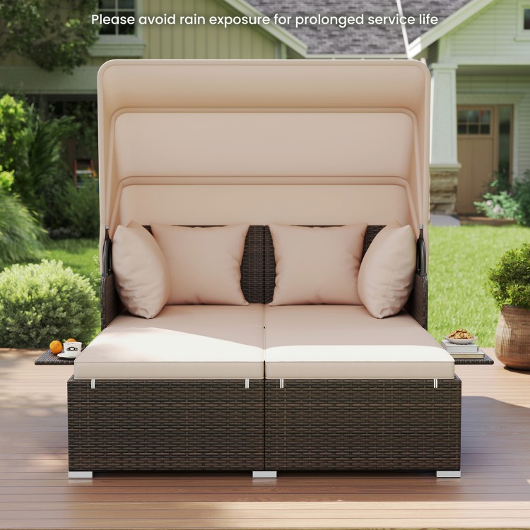 Outdoor patio rattan daybed with retractable canopy and beige cushions, perfect for backyard relaxation and sunshade.