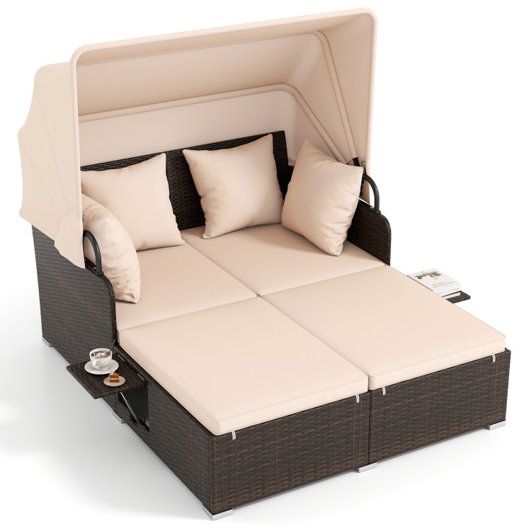 Outdoor patio rattan daybed with beige cushions and retractable canopy, perfect for backyard relaxation with side.