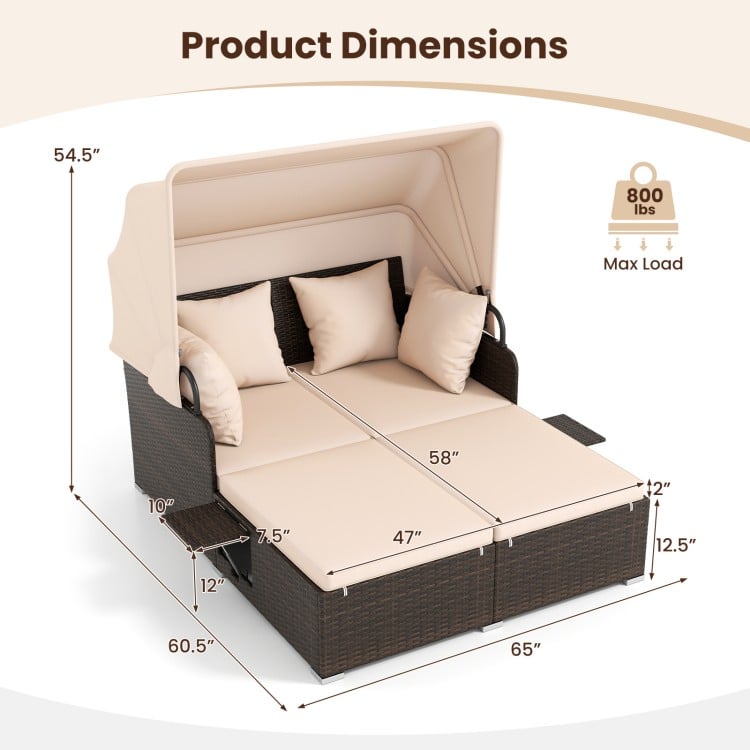 Outdoor patio rattan daybed with retractable canopy, beige cushions, and foldable side tables for backyard relaxation.