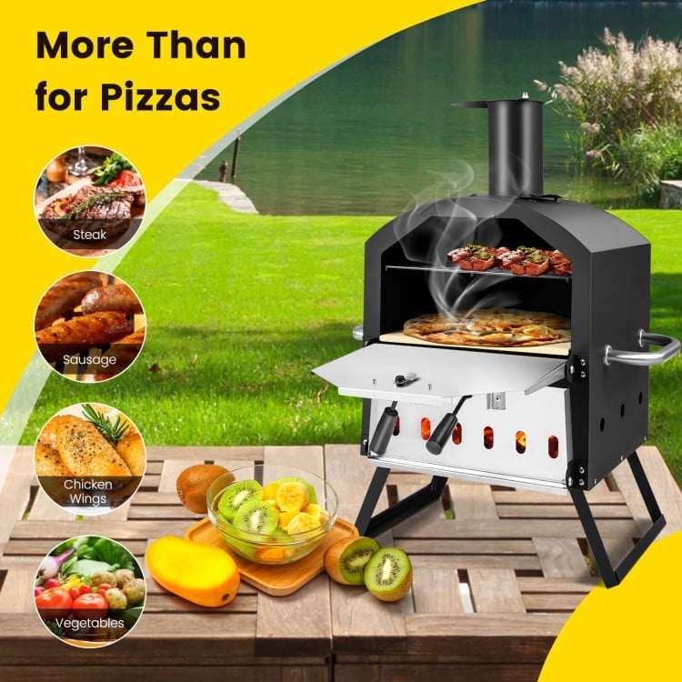 Outdoor pizza oven in black with foldable legs, cooking two pizzas, ideal for steak and chicken wings outdoors.