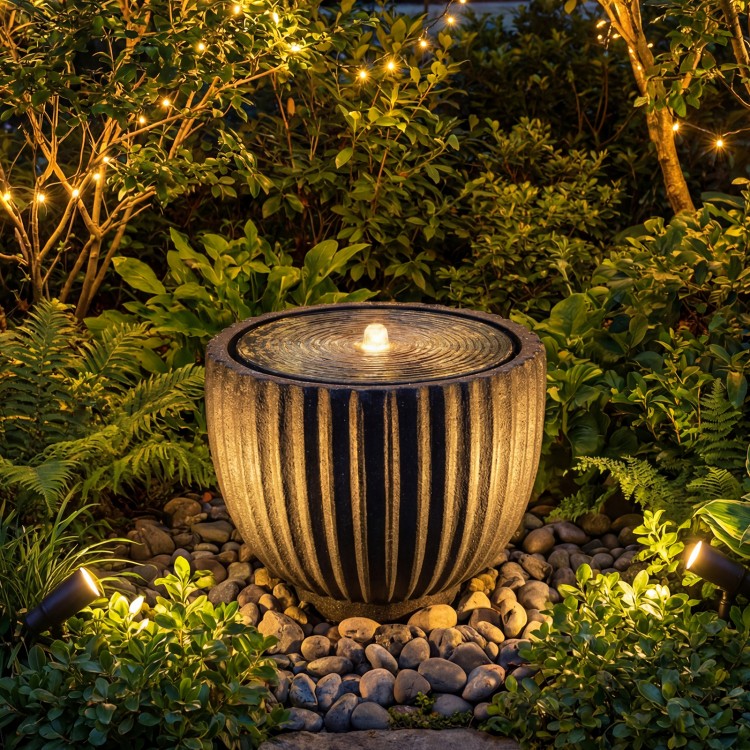 Round sphere water fountain with LED lights, durable resin, and a realistic stone look, perfect for garden tranquility.