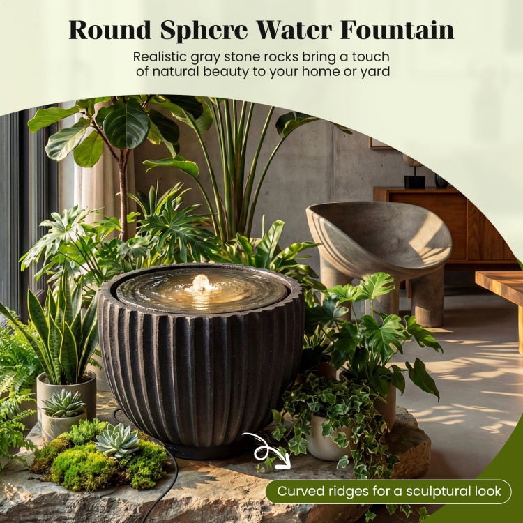 Round sphere water fountain with realistic stone look, curved ridges, and LED lights for tranquil garden ambiance.