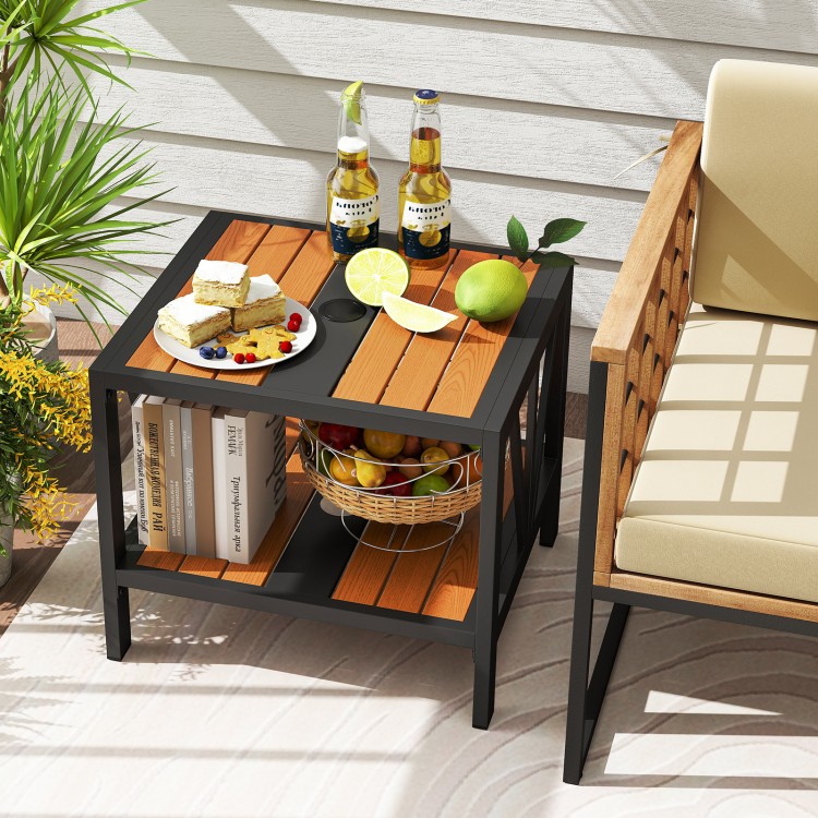 Outdoor side table with umbrella hole and storage shelf, featuring a rustic wood-like surface for patio or porch use.