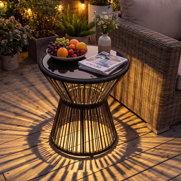 Outdoor side table with LED warm light and tempered glass top, featuring a black PE rattan design for patio elegance.