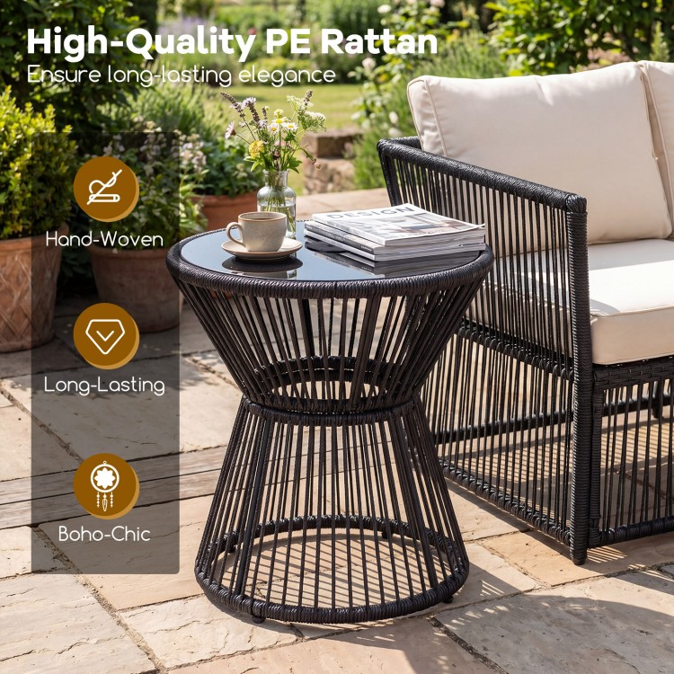 Outdoor side table in black with tempered glass top, featuring hand-woven PE rattan for a boho-chic look, ideal for.