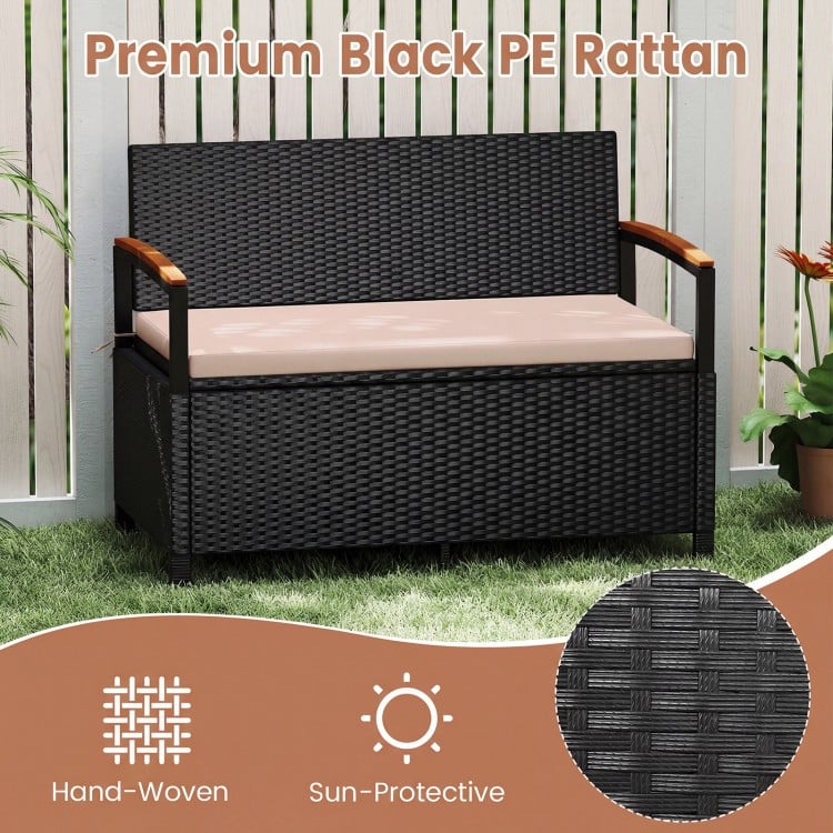 Outdoor storage bench in black PE rattan with brown cushion, featuring acacia wood armrests for patio comfort.