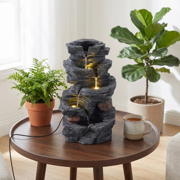 5-tier tabletop water fountain with LED lights and realistic stone gray finish, creating a calming ambiance indoors.