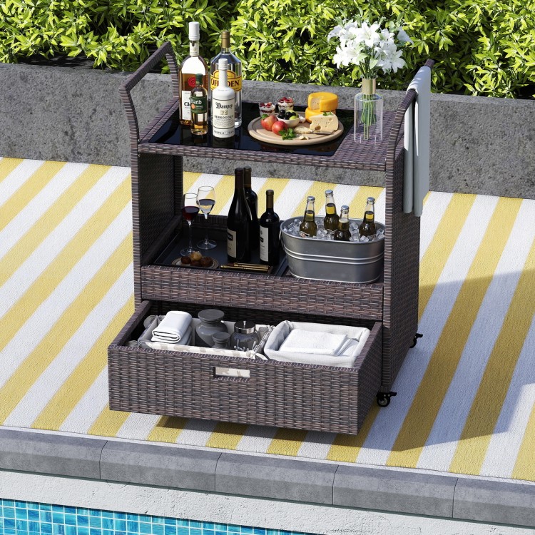 Outdoor wicker bar cart with tempered glass top, featuring ample storage and wheels for easy mobility, perfect for.