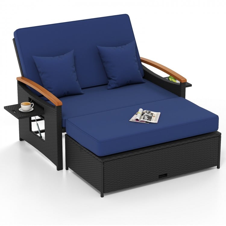 Outdoor wicker daybed in dark blue with adjustable backrest, storage ottoman, and comfortable cushions for patio.