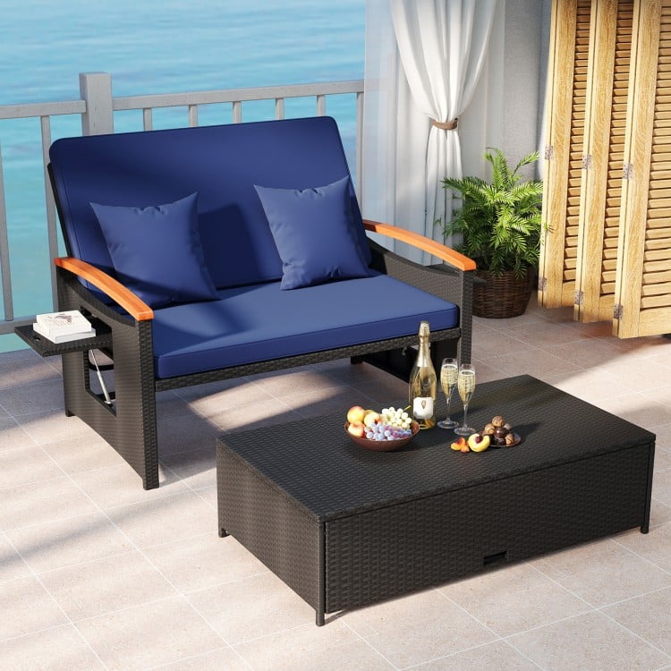 Dark blue outdoor wicker daybed with a spacious storage ottoman and elegant PE rattan for stylish patio lounging.
