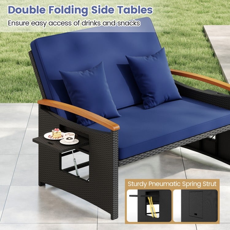 Outdoor wicker daybed in dark blue with double folding side tables for easy access to drinks and snacks.