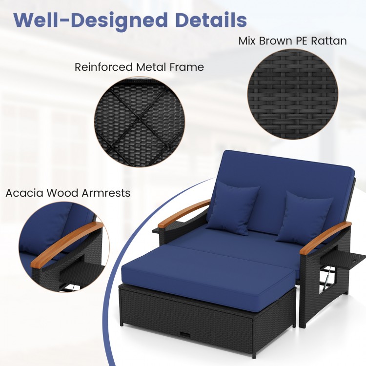 Outdoor wicker daybed with dark blue cushions, acacia wood armrests, and storage ottoman for versatile patio use.