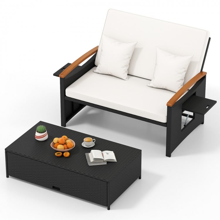 Outdoor wicker loveseat with white cushions, adjustable backrest, and storage ottoman for patio relaxation.