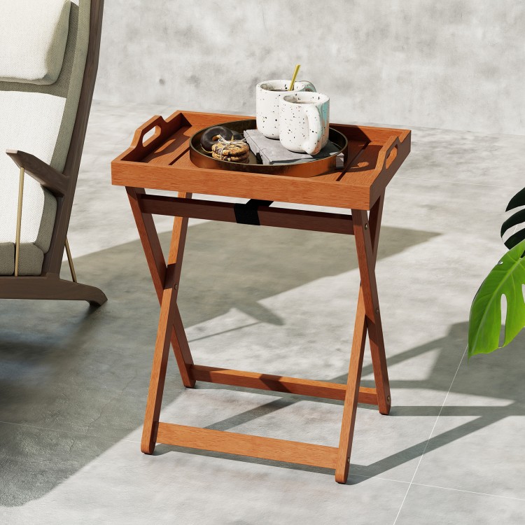 Portable outdoor wood tray table with folding frame, featuring a removable tray and side cut-out handles for easy.