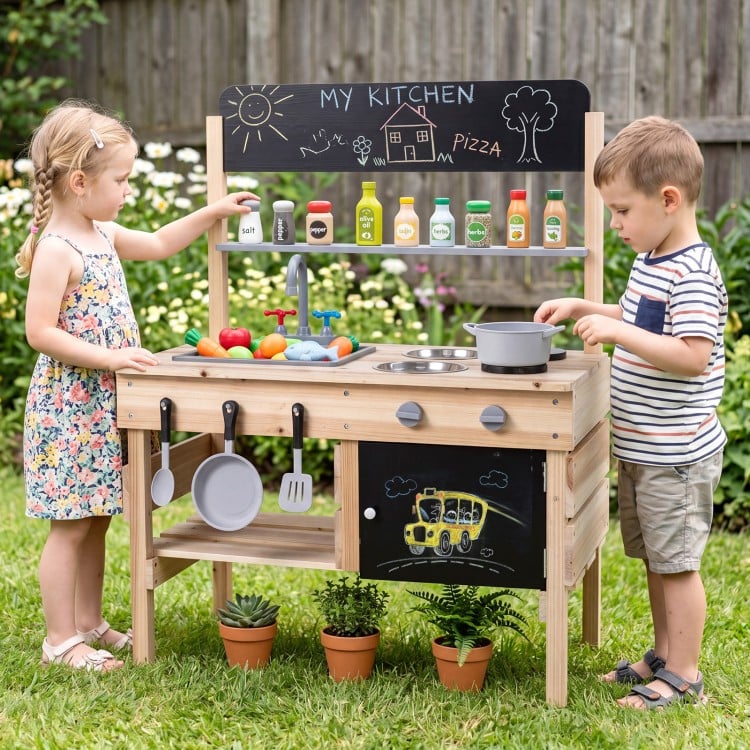 Wooden outdoor mud kitchen for kids featuring stoves, sinks, storage, and blackboards for imaginative play and.