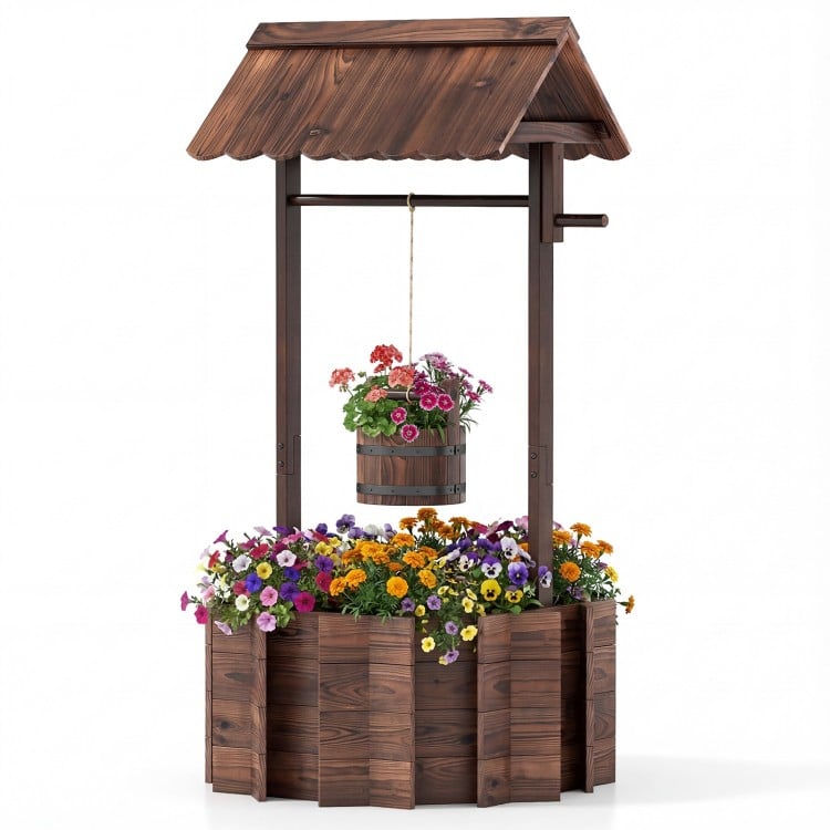 Outdoor wooden wishing well planter with burnt-like wood finish, featuring a hanging bucket for smaller plants.
