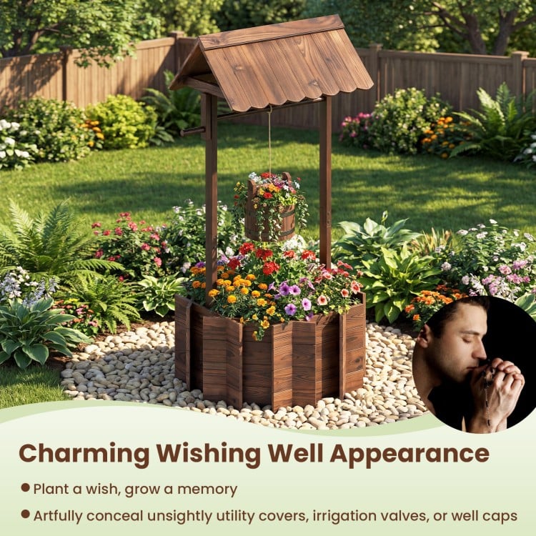 Outdoor wooden wishing well planter bucket with rustic burnt-like finish, perfect for growing flowers in your garden.