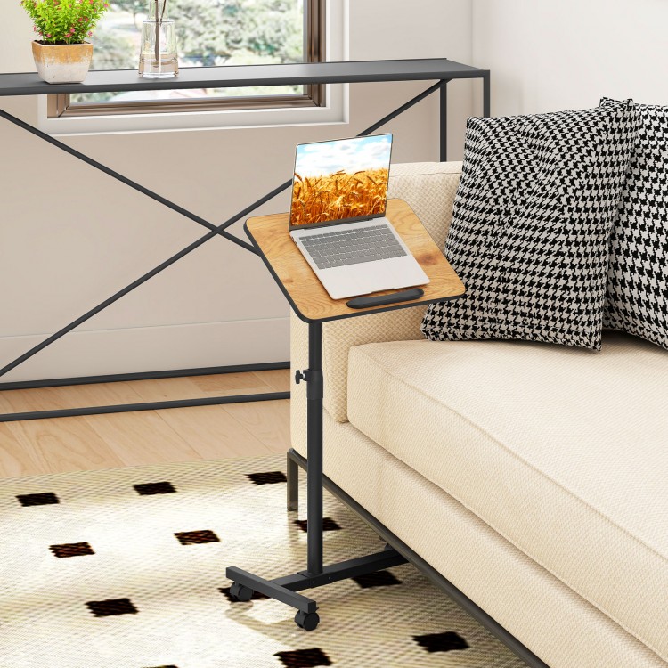 Rolling food tray table with adjustable height, 360° rotating surface, and wheeled base for easy mobility beside a sofa.