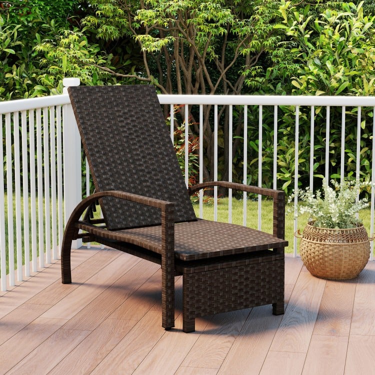 Patio chaise lounge with retractable ottoman, ergonomic design, and durable rattan, perfect for backyard relaxation.
