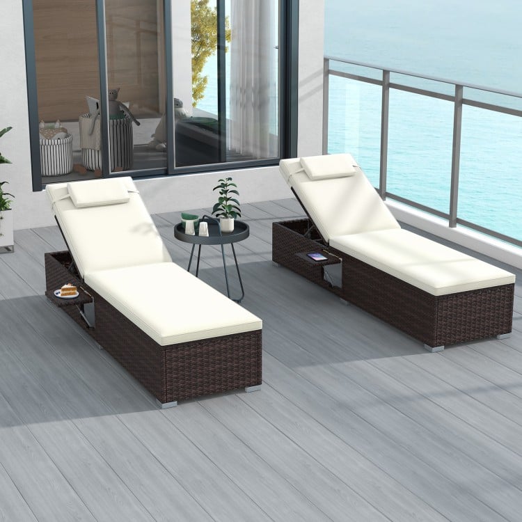 Side view of a patio chaise lounge set with off-white cushions, showcasing elegant rattan weave and foldable side table.