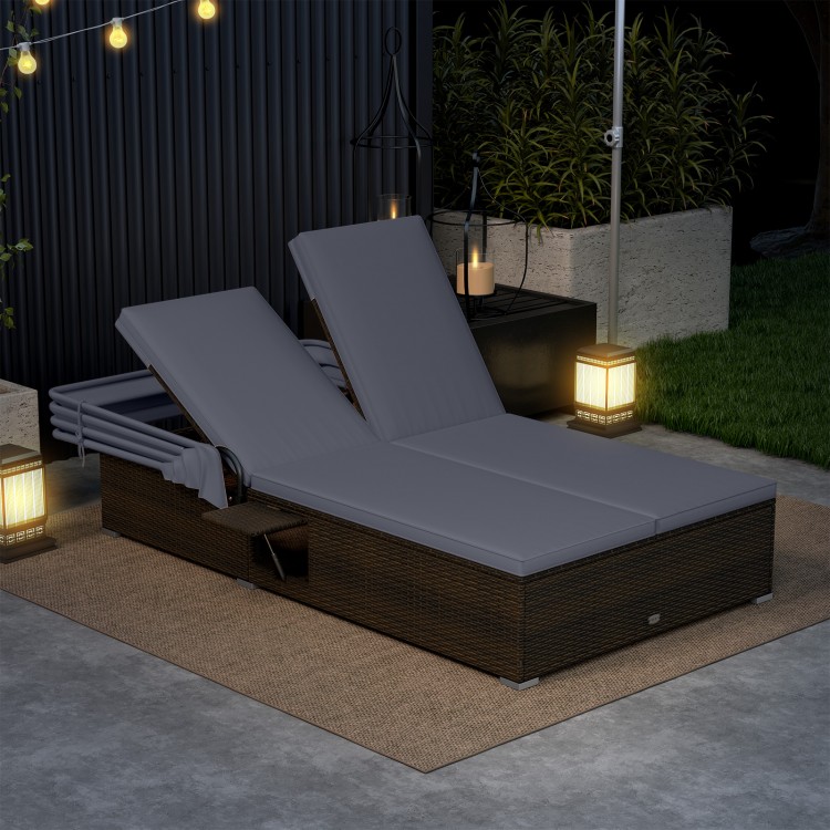 Patio double chaise lounge in gray with adjustable backrests, retractable canopy, and folding side trays for outdoor.